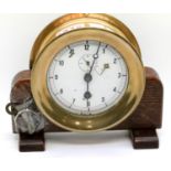 Heavy brass port hole type clock on wood stand by the Chelsea Clock Co, USA. P&P Group 3 (£25+VAT