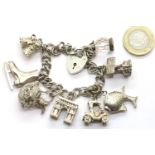 Silver charm bracelet with padlock clasp with eight charms, 46g. P&P Group 1 (£14+VAT for the