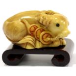 Vintage hand carved tagua nut ox, signed to base of tail, including stand. P&P Group 1 (£14+VAT