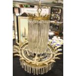 Impressive gilt brass electrolier with cut glass drops, the frame with acanthus leaves (two