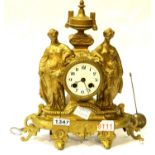 Antique gilt cast metal chiming clock depicting two Grecian ladies in full dress either side of