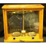 Pair of balancing scales in wood/glass box. Not available for in-house P&P