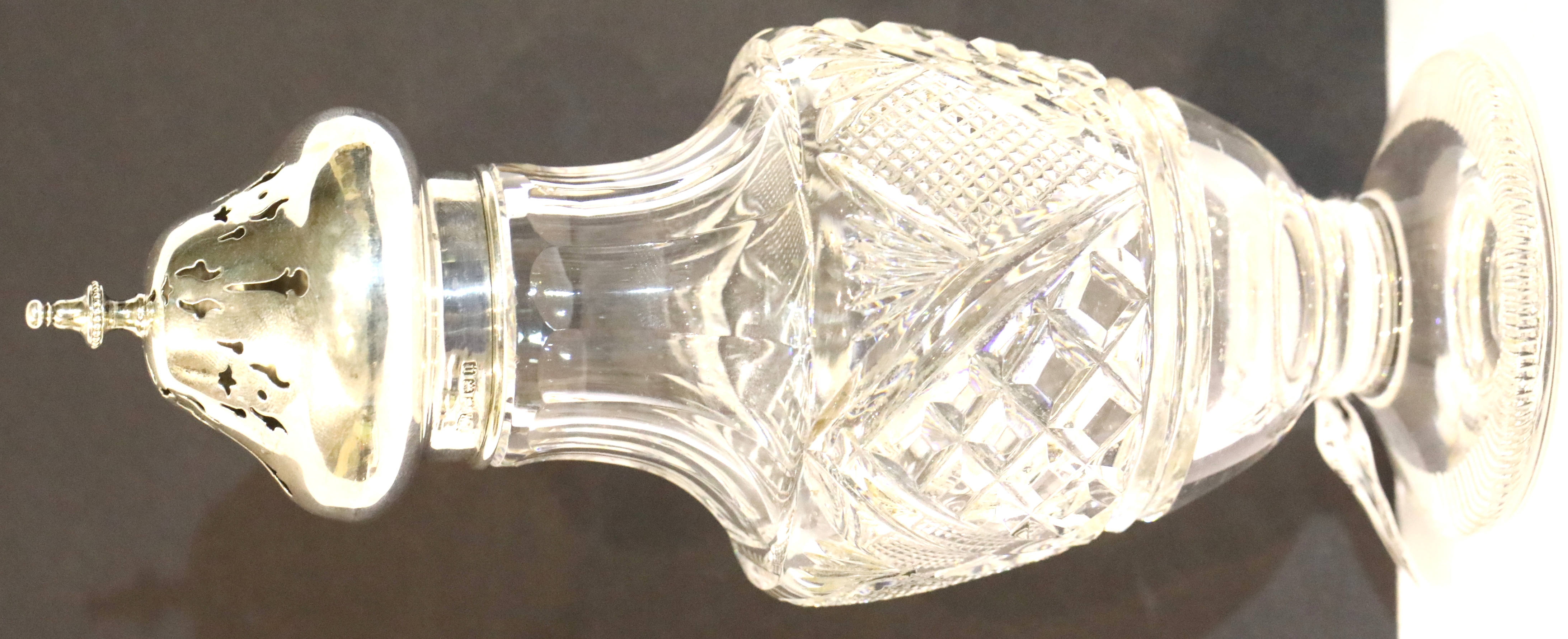 Cut glass silver topped sugar castor hallmarked Birmingham 1912, H: 20 cm, W; 8 cm. P&P Group 2 (£