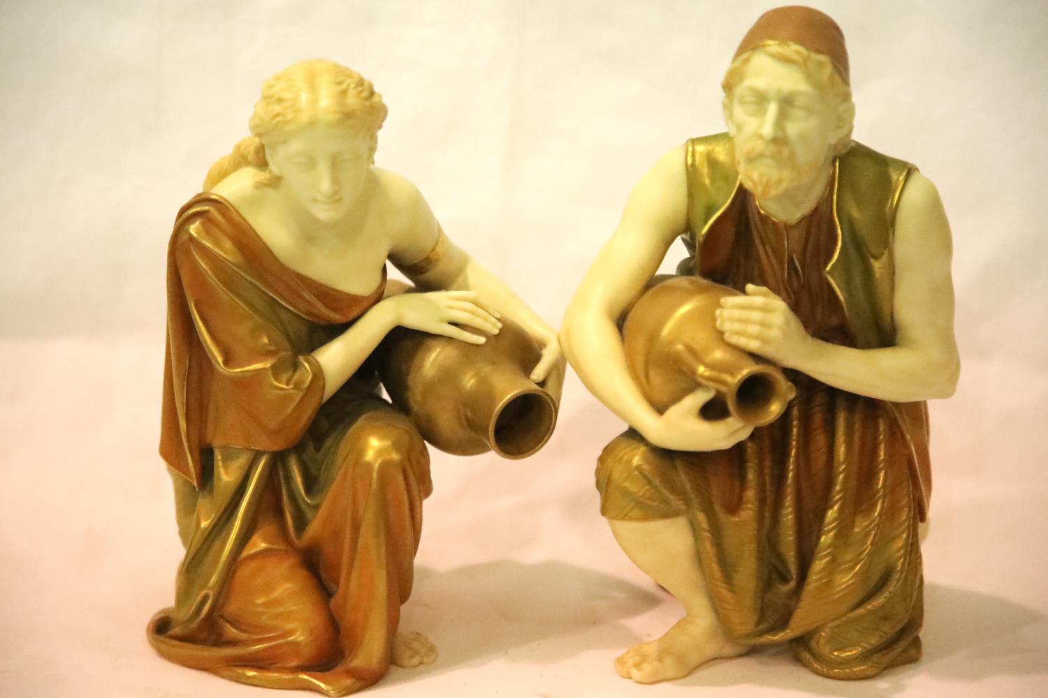 A pair of Royal Worcester figures of water carriers, after James Hadley, H: 25 cm, no visible chips,