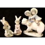 Lladro inuit children on a polar bear and two figures with flowers. P&P Group 2 (£18+VAT for the