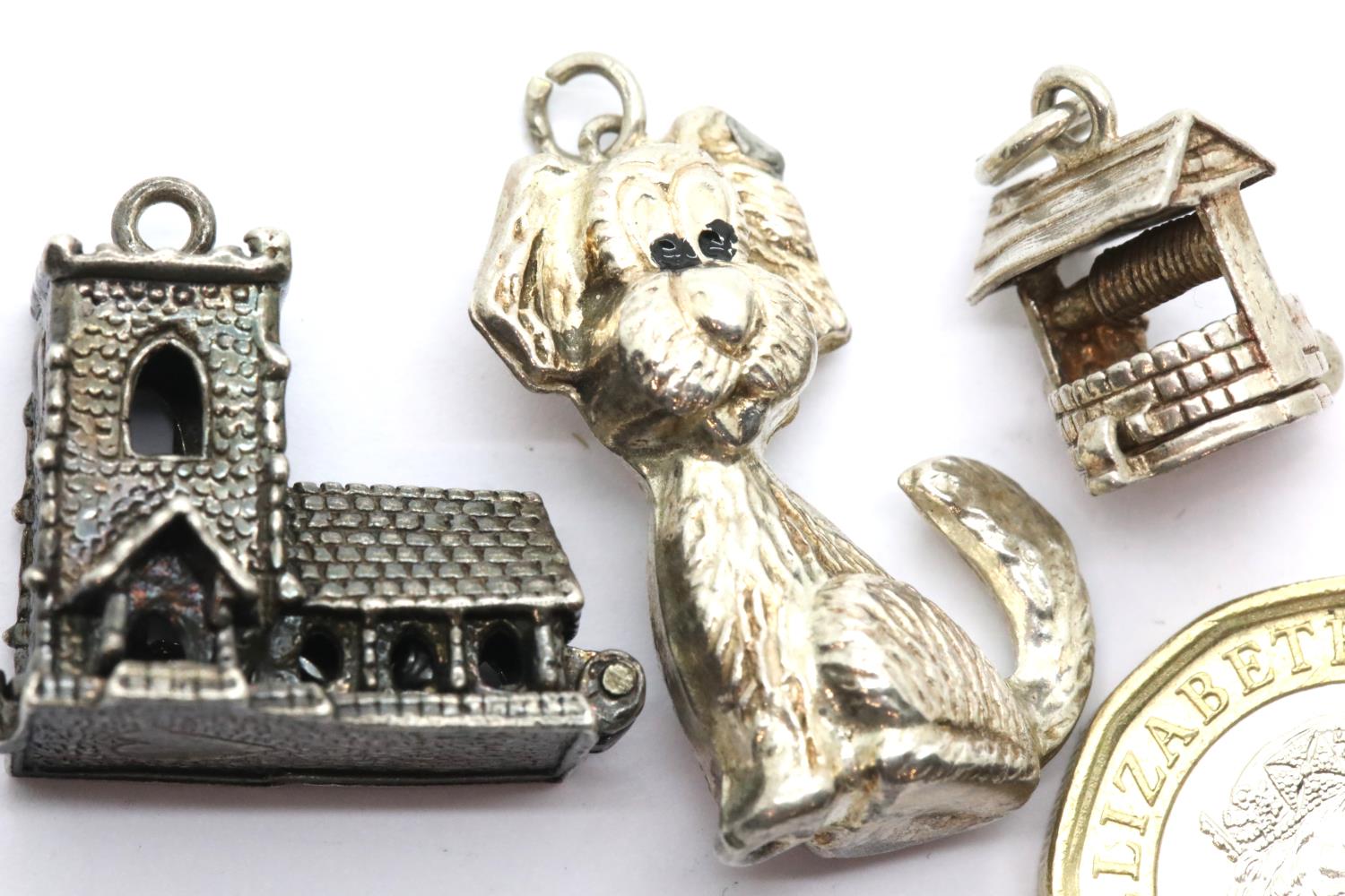 Three 70s vintage silver charms, Church, well and dog. P&P Group 1 (£14+VAT for the first lot and £