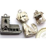 Three 70s vintage silver charms, Church, well and dog. P&P Group 1 (£14+VAT for the first lot and £