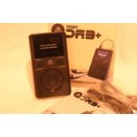 Pocket DAB+ radio with earphones, inbuilt rechargeable battery, has an auto adjusting clock,