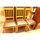 Set of three pine/leather effect seated dining chairs. Not available for in-house P&P