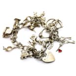 Silver charm bracelet with twelve charms, 27g. P&P Group 1 (£14+VAT for the first lot and £1+VAT for