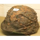 German WWII type combat M35 helmet with SS reversible camouflage cover, with liner and chin strap.