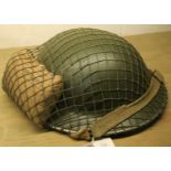 British WWII type Tommy helmet with net and field dressing dated 1941. P&P Group 2 (£18+VAT for