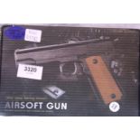 Airsoft V11 tan coloured hand gun, boxed. P&P Group 1 (£14+VAT for the first lot and £1+VAT for