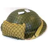 British WWII type Tommy helmet with net and field dressing dated 1941. P&P Group 2 (£18+VAT for