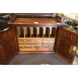 A Victorian inlaid mahogany table top cabinet with galleried top and two carved doors, having a