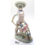 Lladro child pushing wheelbarrow full of flowers, damage to some of the flowers. Not available for