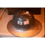 Military helmet of indeterminate age, showing possible battle damage. P&P Group 1 (£14+VAT for the