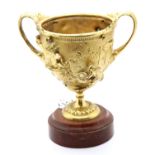 19th century Grand Tour gilt bronze twin handled chalice with relief casting raised on circular