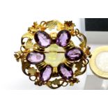 Victorian gilt metal amethyst type brooch, D: 4 cm. P&P Group 1 (£14+VAT for the first lot and £1+