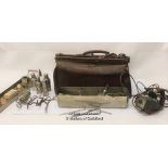 A leather Gladstone type medical doctor's bag with various eqipment therein.