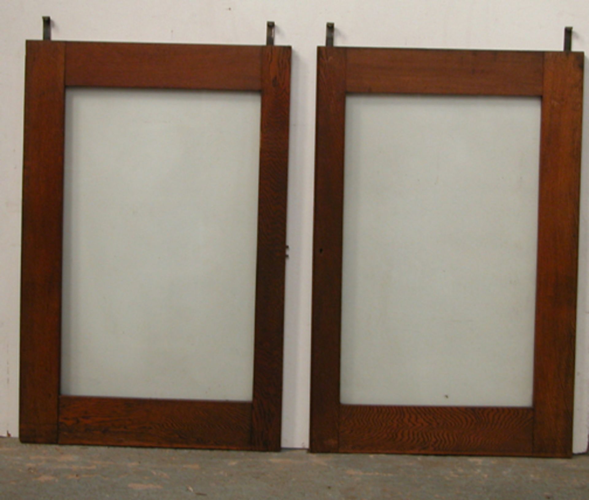 *PAIR OF RECLAIMED GLAZED OAK SCREENS FROM AN ORGAN CASE, CIRCA 1900. HEIGHT 1000MM (39.25IN) X