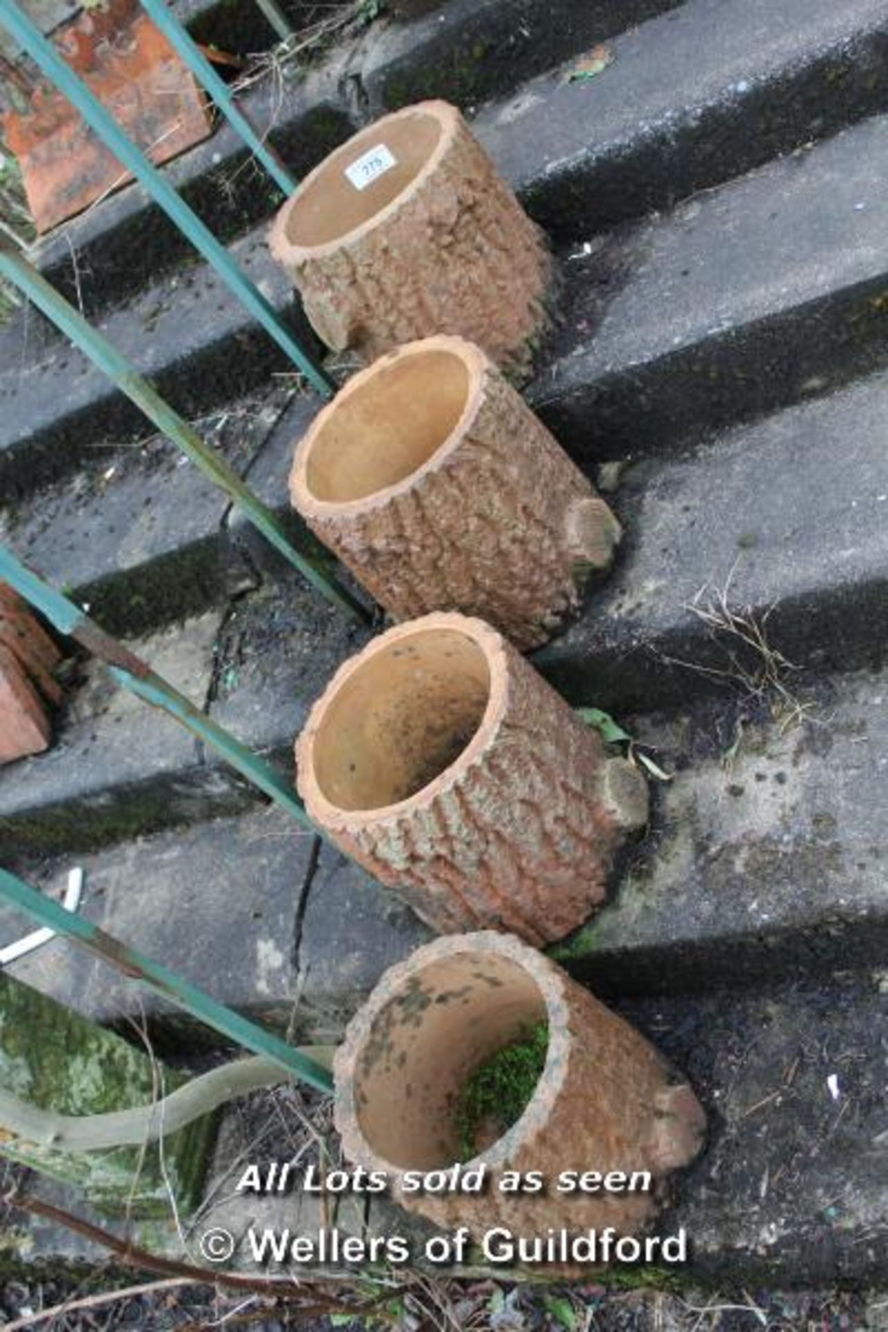 *FOUR CLAY TREE TRUNK FORM PLANTERS