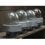 *FOUR ALLOY ENCLOSED FACTORY BULKHEAD LIGHTS, CLEANED AND WAXED, CIRCA 1960. HEIGHT 285MM (11.