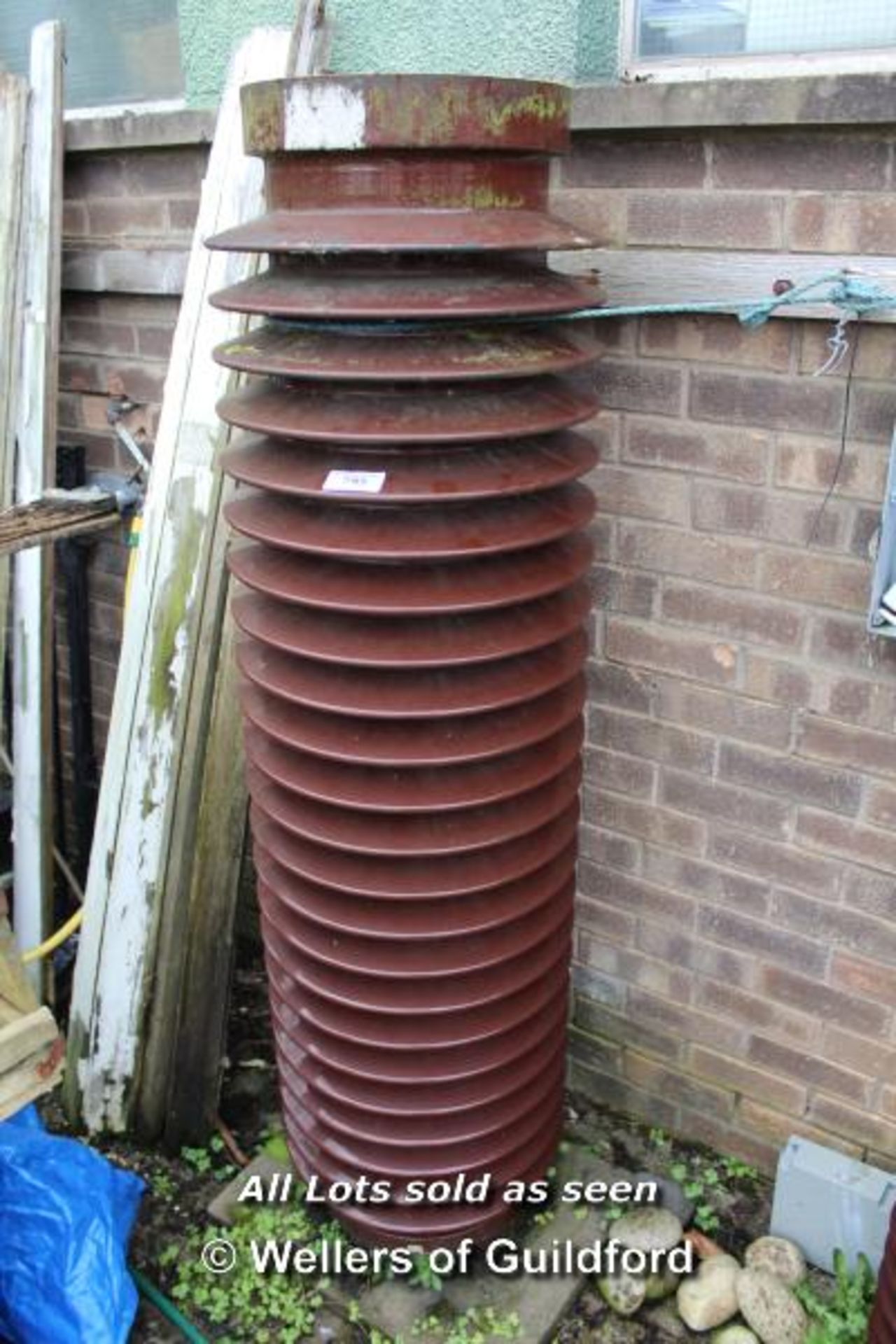 *CERAMIC ELECTRICITY INSULATOR, SET UP AS A WATER FEATURE. LATE 1900S