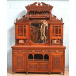 *LARGE CARVED MAHOGANY SIDEBOARD WITH BEVELLED GLASS IN THE DOORS, CIRCA 1890. HEIGHT 2520MM (99.