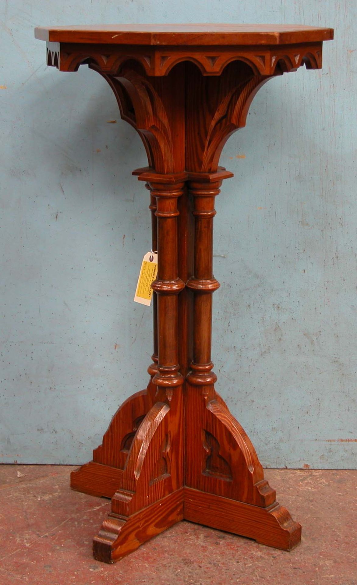 *PITCH PINE GOTHIC STAND WITH OCTAGONAL TOP AND TURNED COLUMNS. CIRCA 1890. 1035MM (40.75IN) HIGH