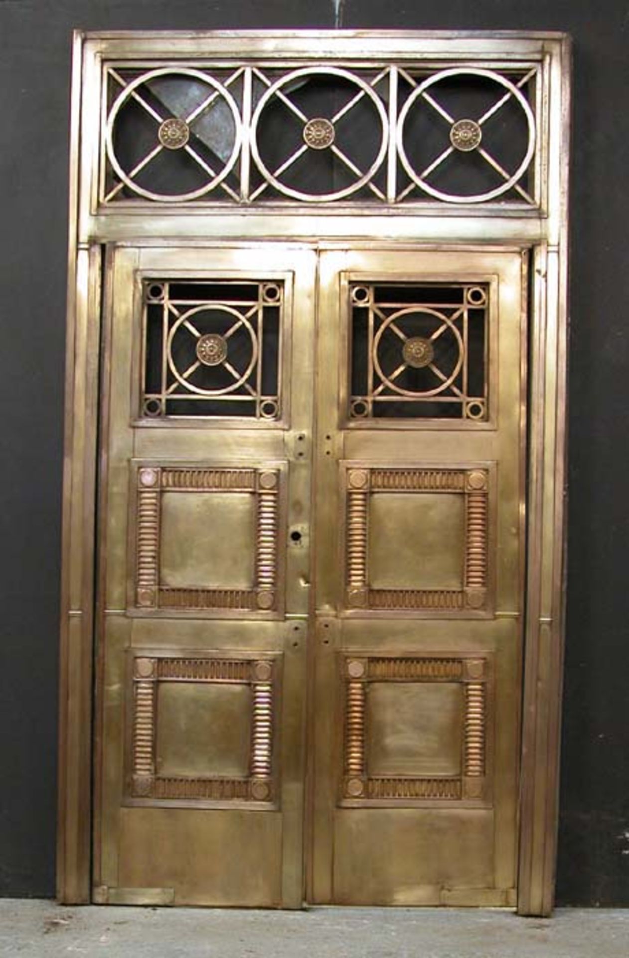 *BRONZE ENTRYWAY WITH MATCHING BRONZE DOORS, CIRCA 1900. SURROUND WIDTH 1635MM (64.25IN) X HEIGHT