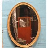 *LARGE OVAL MIRROR BY JONATHAN SAINSBURY IN THE STYLE OF GEORGE III WITH CARVED MOULDED FRAME.