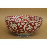 A Chinese Bowl Decorated With White Prunus On Red Ground, 18cm Diameter