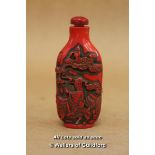 A Chinese Red Snuff Bottle Carved With Figures And A Dragon