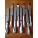 Eight loaded silver handled, shell decoration Dinner knives