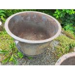 A cast Iron Planter in a metal frame