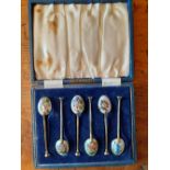 A boxed set of silver gilt coffee spoons with different enamelled flowers to the bowl Birmingham 1
