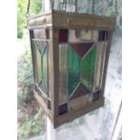 A Victorian brass hanging lantern with coloured glass panels