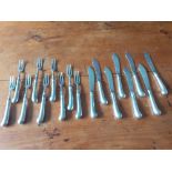 Eight silver blade and loaded silver handled fish knives and nine forks. With pistol handles London