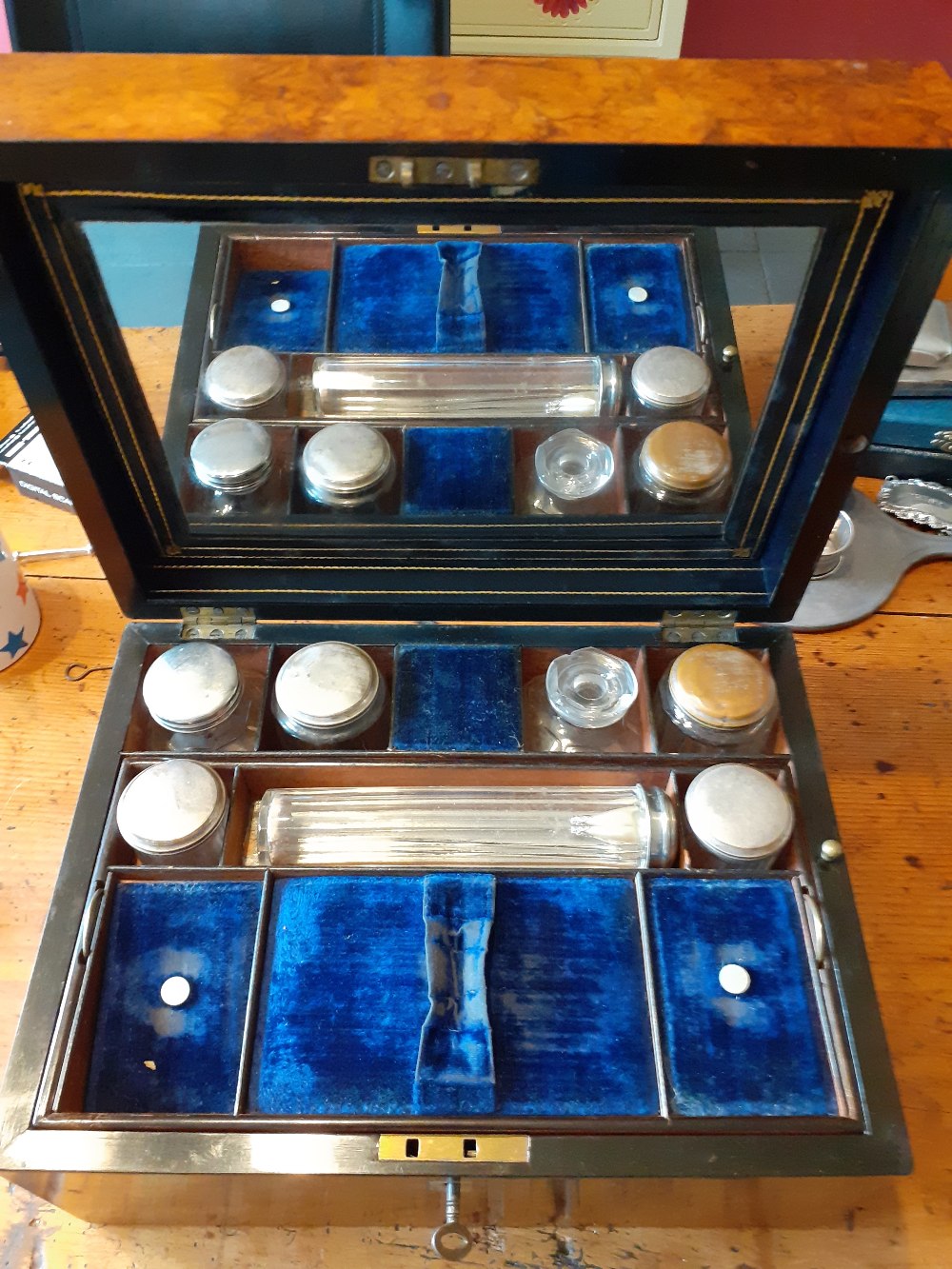 19th century Burr Walnut veneered dressing case with blue silk liner and silver plated bottles.