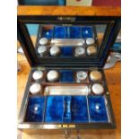 19th century Burr Walnut veneered dressing case with blue silk liner and silver plated bottles.