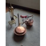 A Victorian copper kettle, warming pan, trivet, fire irons and wooden bellows.