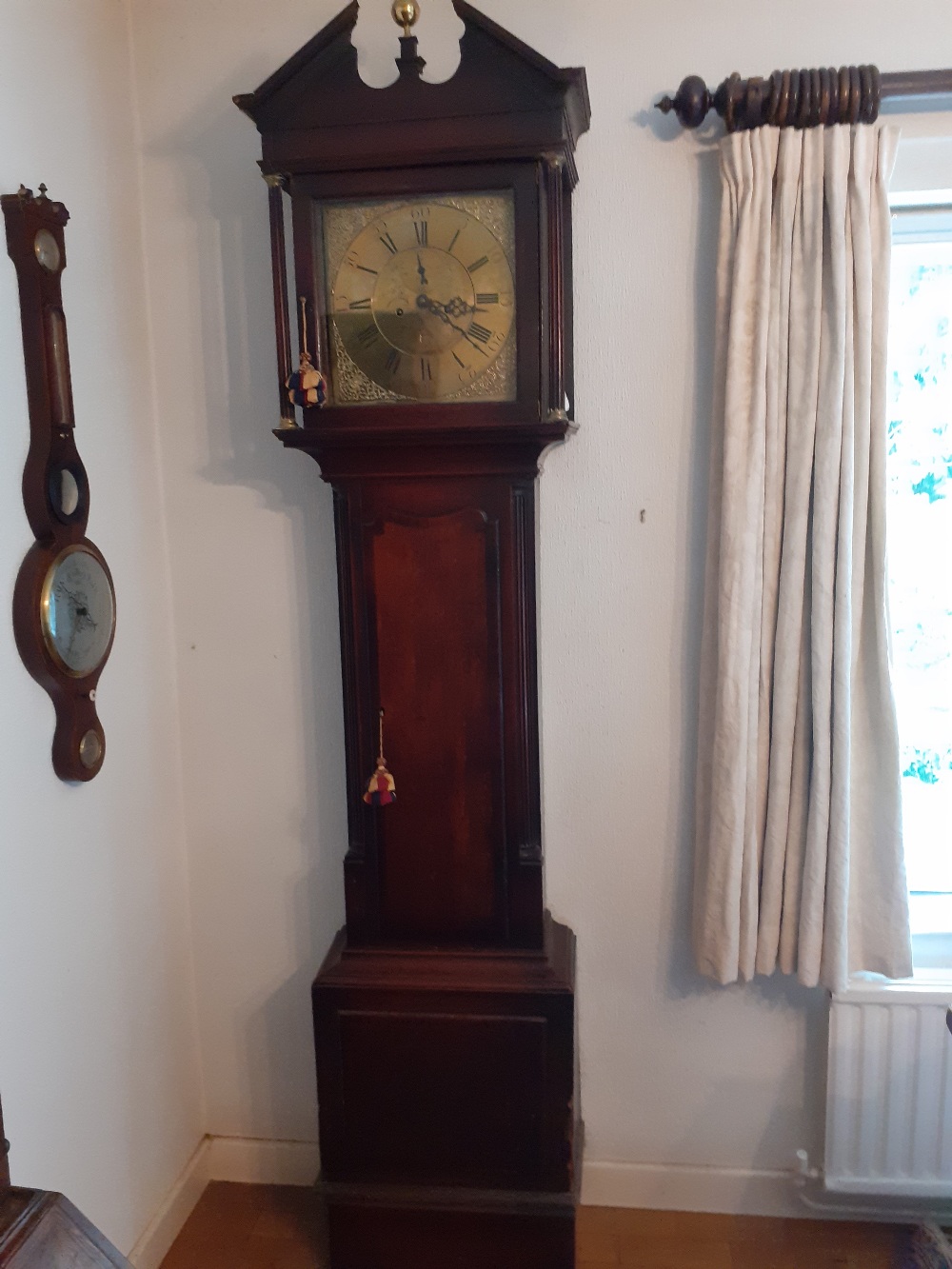 An 18th century/Early 19th Century eight day brass faced oak and mahogany long case clock by Robert