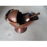 A Victorian Copper Helmet Coal scuttle with copper scoop