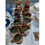 A collection of 11 Victorian Lustre jug varying heights 30/50