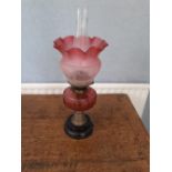 A Victorian glass Oil lamp with etched cranberry glass shade