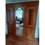 A 19th century Sheraton style double inlayed mahogany wardrobe