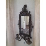 A Victorian cast brass wall mirror with cherub top