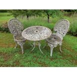 A cast Victorian style table and two chairs