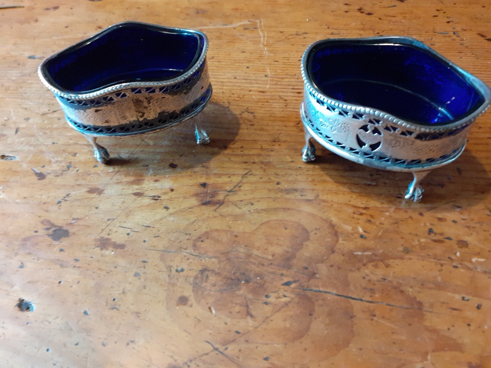 A pair of Georgian style silver salts on four ball and claw feet.